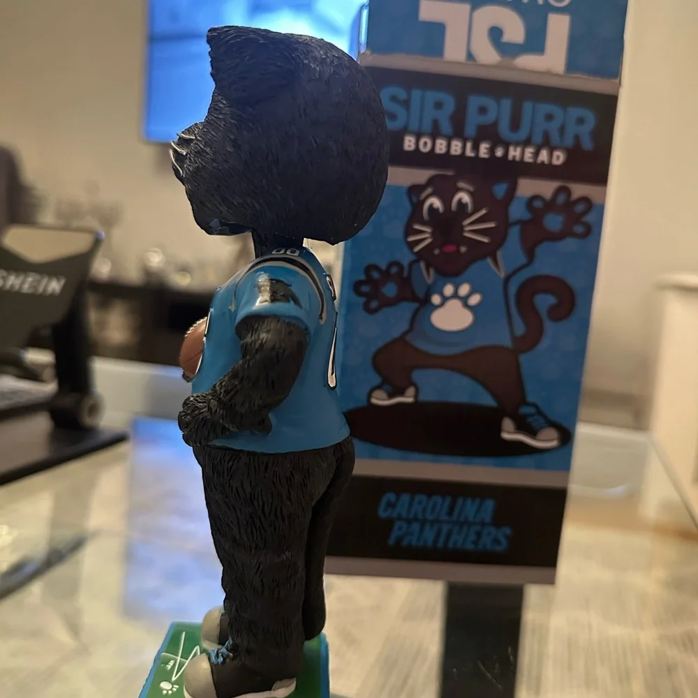 The item in the image is a Sir Purr Carolina Panthers mascot figurine/statue.